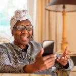 Happy senior using an easy mobile phone for seniors