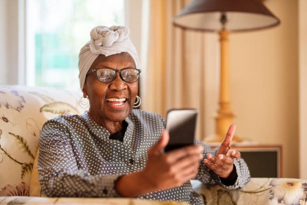 Happy senior using an easy mobile phone for seniors